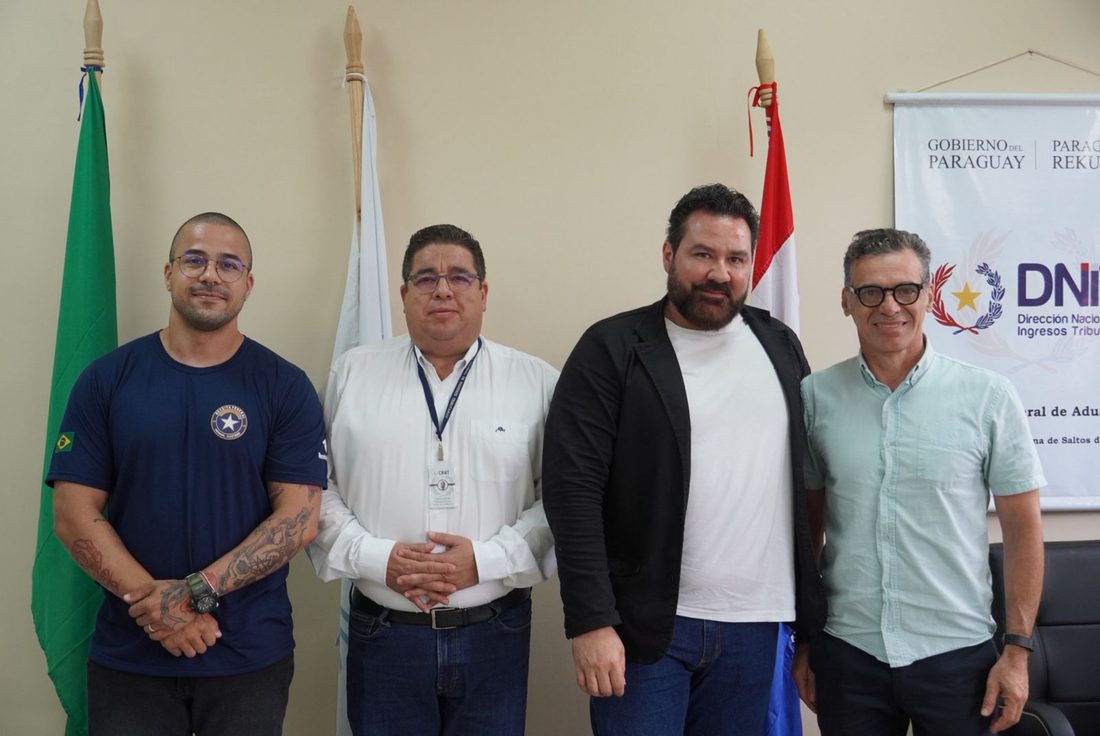 Reunião institucional da Omni Hold com autoridades paraguaias, com bandeiras do Brasil e do Paraguay